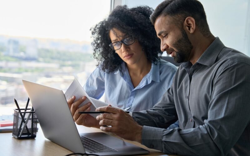 Multiethnic,Male,Indian,Mentor,And,Female,African,American,Intern,Sitting
